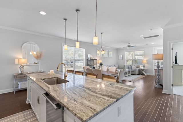 kitchen with white cabinets, sink, a kitchen island with sink, ceiling fan, and light stone counters