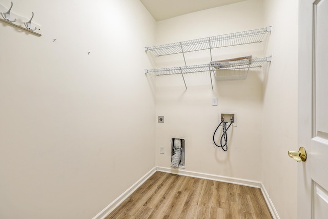 clothes washing area featuring hookup for a washing machine, hookup for an electric dryer, and wood-type flooring