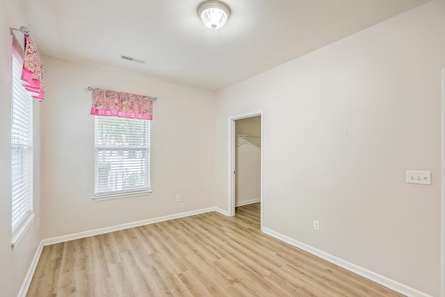 spare room with light hardwood / wood-style flooring