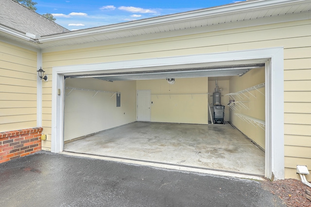 garage with electric panel and wood walls