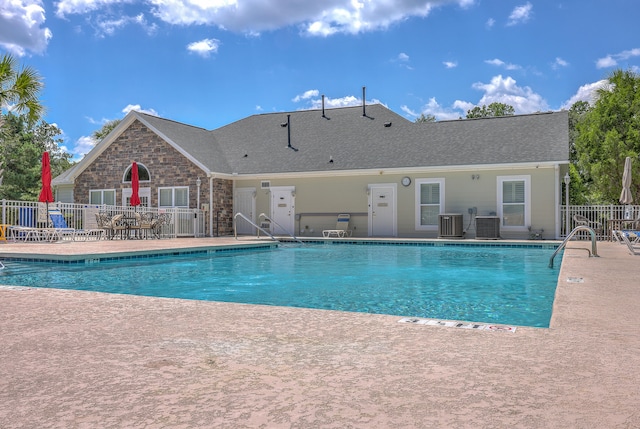 view of pool with central AC unit and a patio area