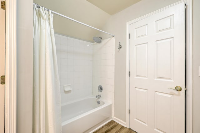 bathroom featuring wood-type flooring and shower / tub combo