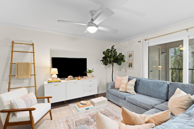 living room with hardwood / wood-style flooring, crown molding, and ceiling fan