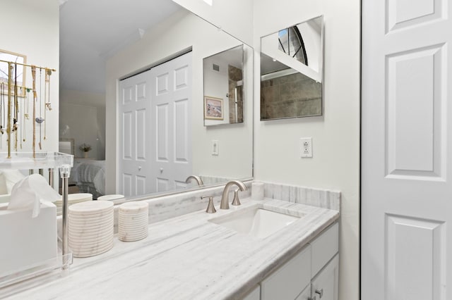 bathroom featuring crown molding and vanity