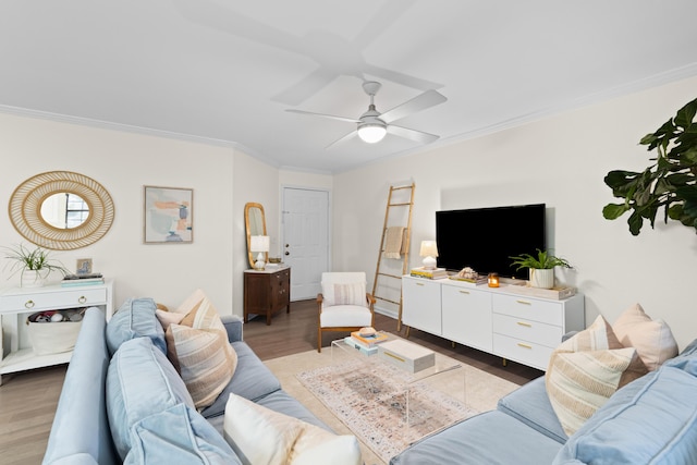 living room with crown molding, ceiling fan, and dark hardwood / wood-style floors