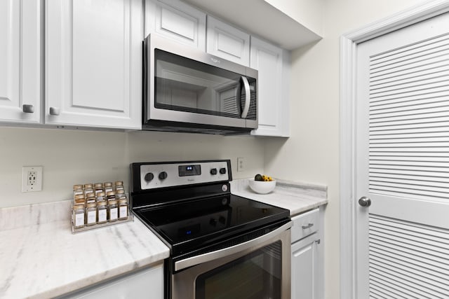 kitchen with stainless steel appliances and white cabinets