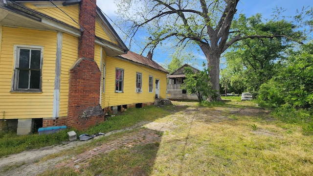 view of side of home featuring a chimney