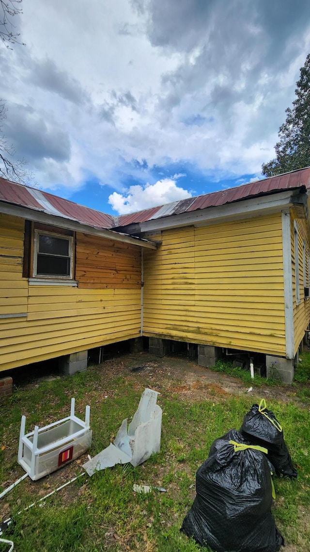 view of home's exterior featuring metal roof