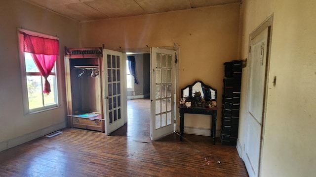 unfurnished bedroom with french doors, wood finished floors, and visible vents
