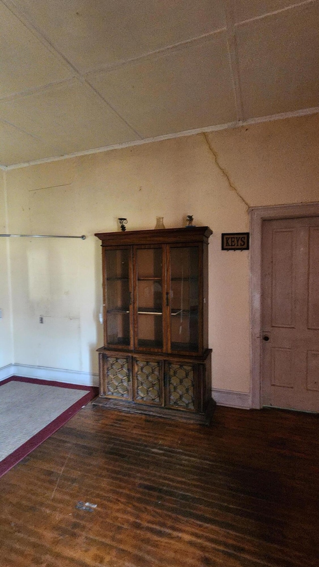 interior space with baseboards and wood finished floors