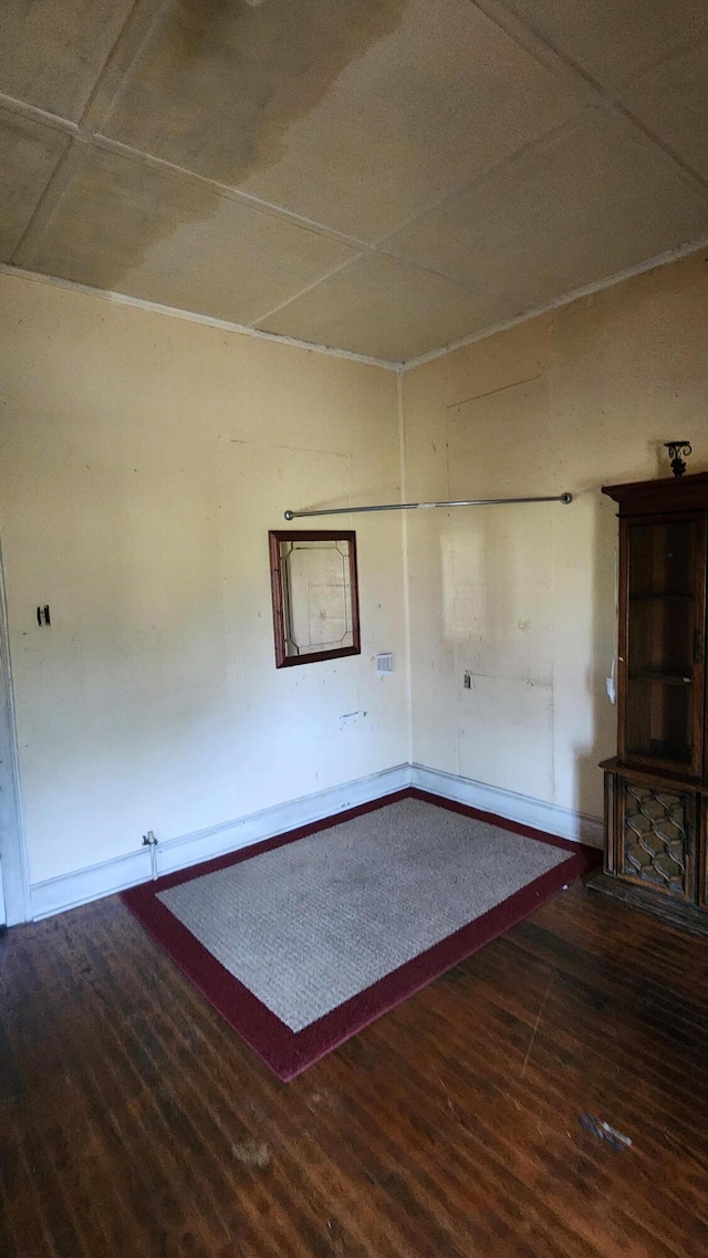 unfurnished living room with wood finished floors and baseboards