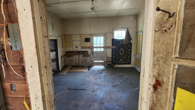 misc room featuring electric panel and concrete floors