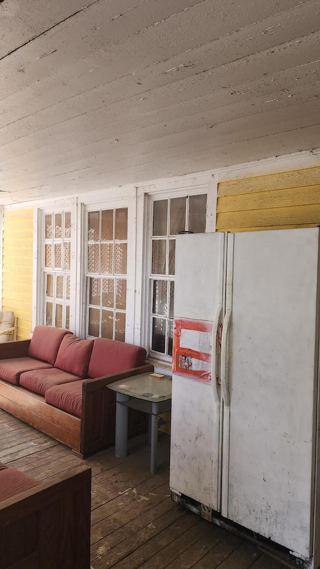 interior space with hardwood / wood-style floors and freestanding refrigerator