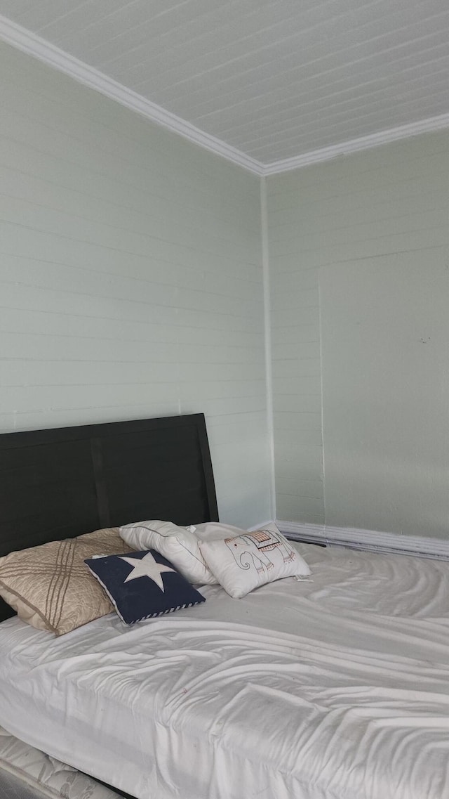 bedroom with baseboards and ornamental molding