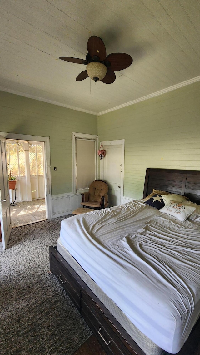 bedroom featuring ceiling fan, carpet floors, and ornamental molding