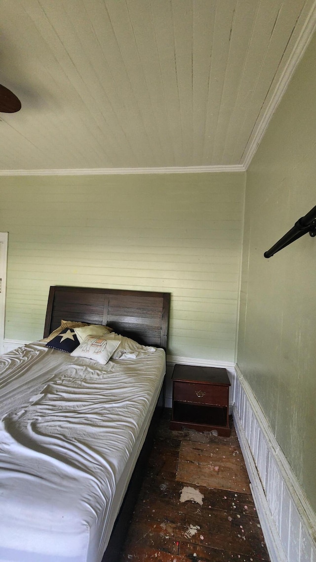 bedroom with ceiling fan, ornamental molding, and wood-type flooring