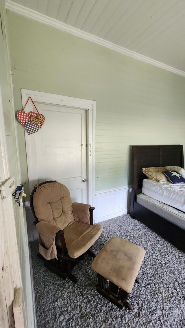 bedroom with ornamental molding and carpet flooring