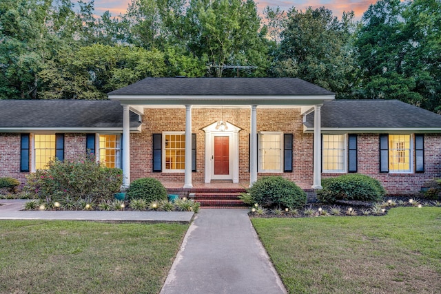 598 Maple Branch Rd, Reevesville, SC 29471 - view of front of home with brick siding, a front lawn, and a porch