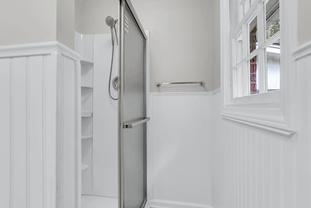 598 Maple Branch Rd, Reevesville, SC 29471 - bathroom with a stall shower, a wainscoted wall, and a decorative wall