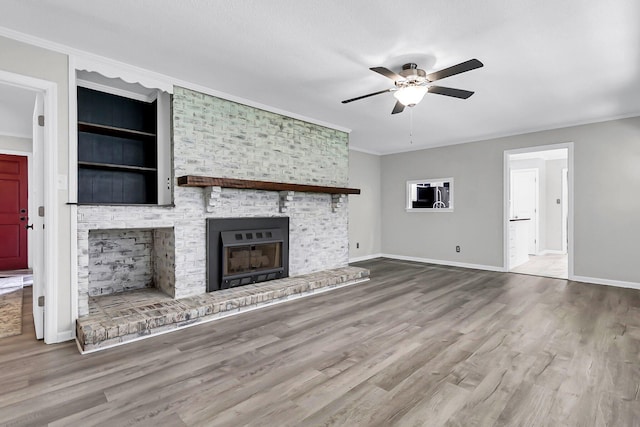 598 Maple Branch Rd, Reevesville, SC 29471 - unfurnished living room featuring ceiling fan, a fireplace, wood finished floors, and crown molding