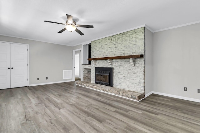598 Maple Branch Rd, Reevesville, SC 29471 - unfurnished living room with crown molding, a ceiling fan, wood finished floors, and a brick fireplace