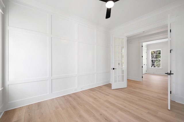 spare room featuring ceiling fan, french doors, light hardwood / wood-style floors, and ornamental molding