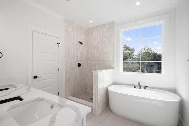 bathroom featuring vanity and independent shower and bath