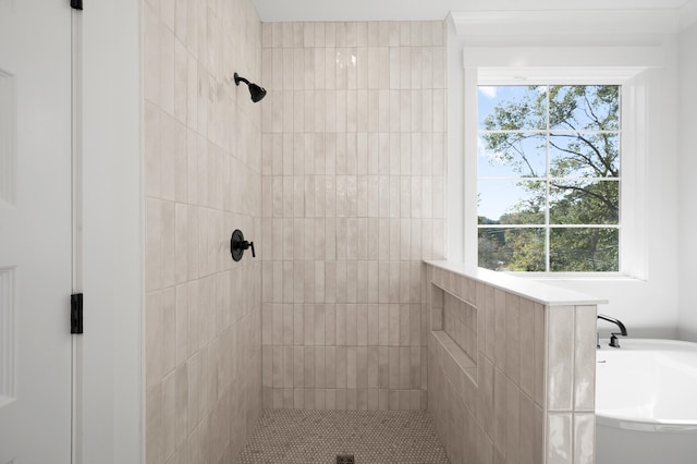 bathroom featuring shower with separate bathtub