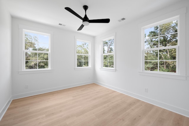 unfurnished room with plenty of natural light and light hardwood / wood-style floors