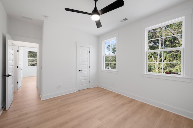 unfurnished bedroom with ceiling fan, a closet, and light wood-type flooring