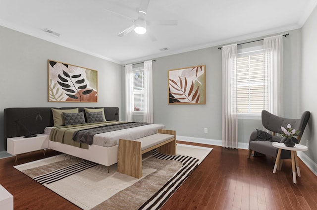 bedroom with crown molding, baseboards, and hardwood / wood-style floors