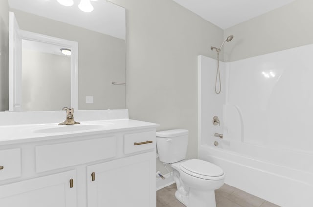 full bathroom with vanity, toilet, tile patterned floors, baseboards, and bathing tub / shower combination