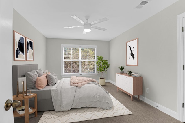 carpeted bedroom featuring baseboards, visible vents, and ceiling fan