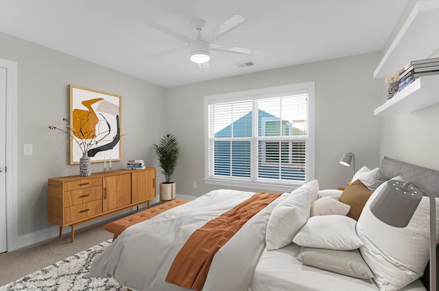 bedroom with baseboards, visible vents, light carpet, and ceiling fan