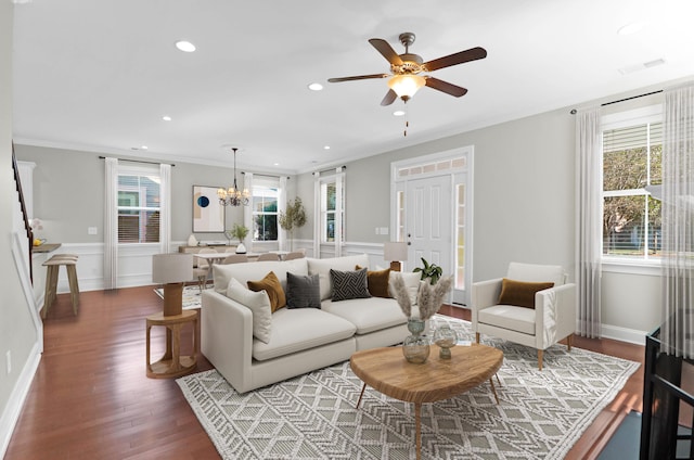 living room with crown molding, visible vents, wood finished floors, recessed lighting, and ceiling fan with notable chandelier