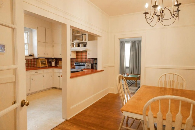 203 Weiters St, Walterboro, SC 29488 - dining area featuring ornamental molding, a chandelier, light wood-style floors, and healthy amount of natural light