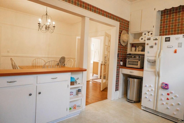 203 Weiters St, Walterboro, SC 29488 - kitchen featuring white refrigerator with ice dispenser, open shelves, a chandelier, and white cabinets