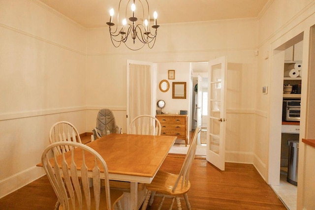 203 Weiters St, Walterboro, SC 29488 - dining room with a chandelier, wood finished floors, crown molding, french doors, and a decorative wall