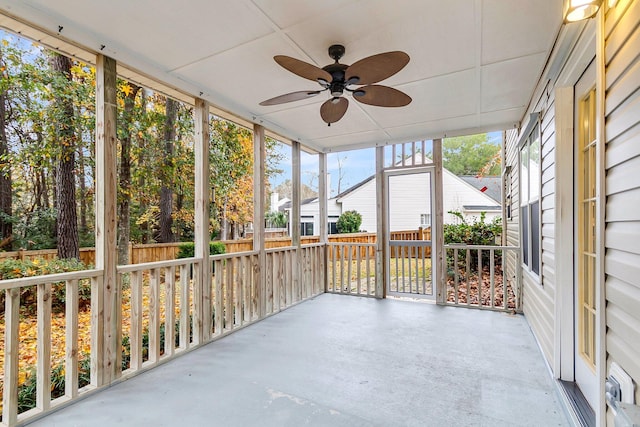 unfurnished sunroom featuring a wealth of natural light and ceiling fan