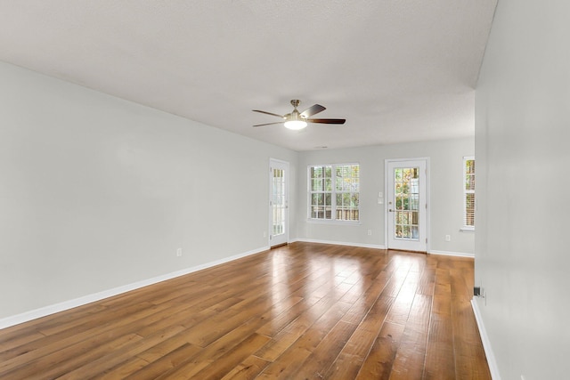 spare room with ceiling fan and dark hardwood / wood-style flooring