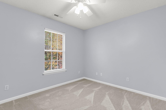 carpeted empty room with a textured ceiling and ceiling fan