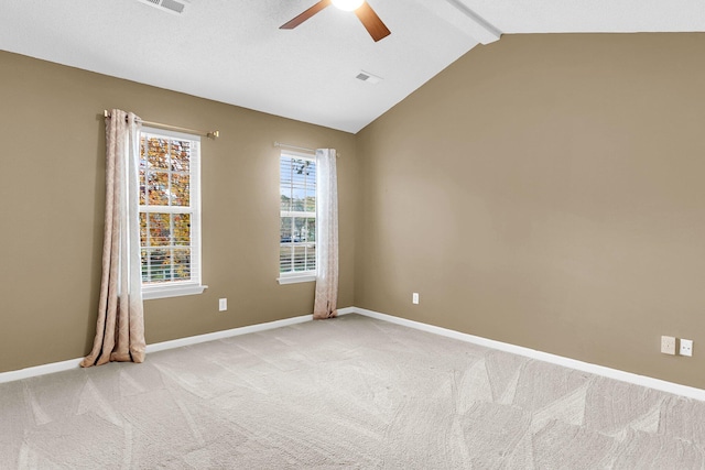 carpeted empty room featuring lofted ceiling with beams and ceiling fan