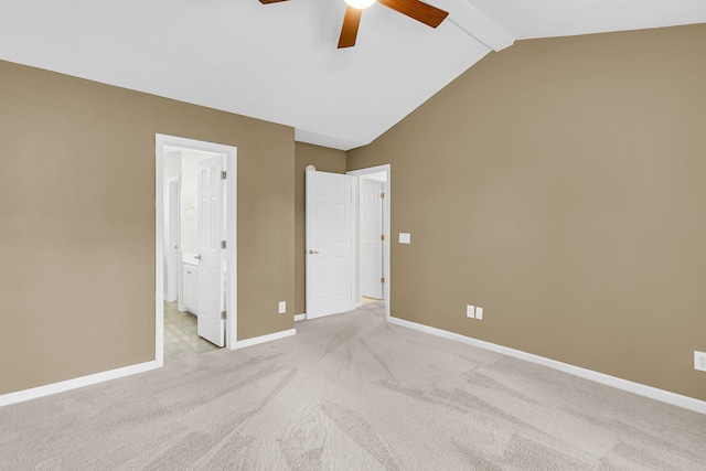 unfurnished bedroom with vaulted ceiling with beams, ensuite bathroom, ceiling fan, and light carpet