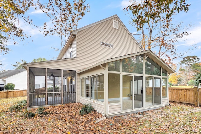 back of property with a sunroom