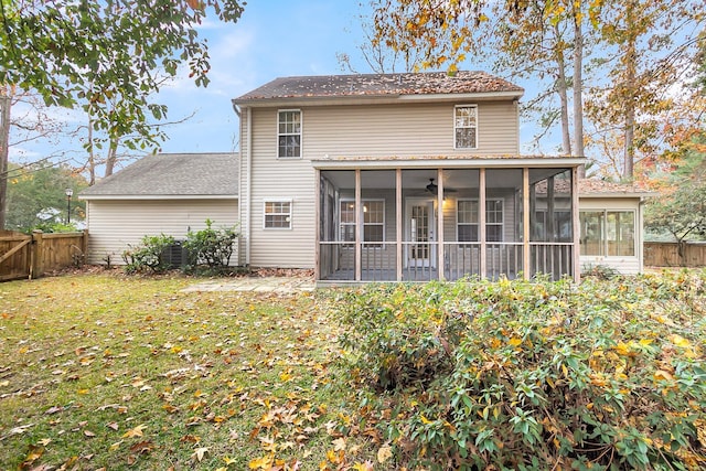 rear view of property with a sunroom and a yard