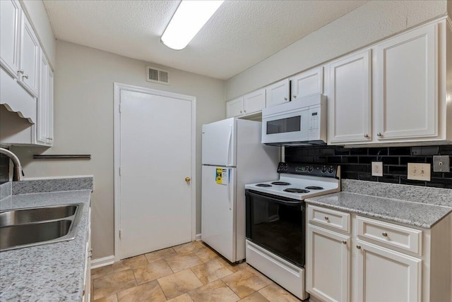 kitchen with backsplash, a textured ceiling, white appliances, sink, and white cabinets