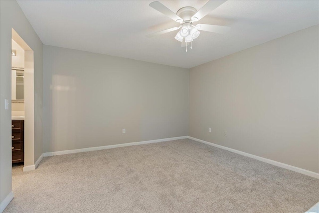 empty room with ceiling fan and light colored carpet