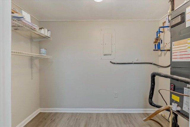 interior space featuring electric panel and heating unit