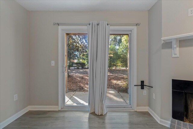 entryway featuring a fireplace and light wood-type flooring