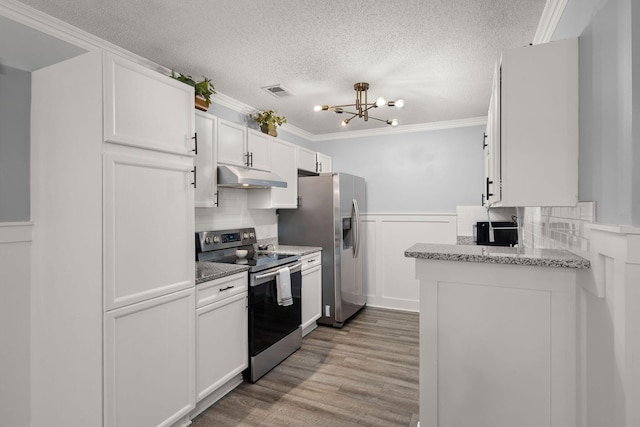 kitchen featuring crown molding, light hardwood / wood-style flooring, appliances with stainless steel finishes, light stone counters, and white cabinets